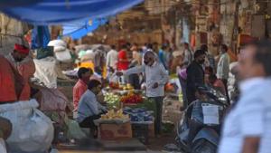 People carrying bundles of vegetables during lockdown, in Azadpur Mandi in New Delhi.(Sanchit Khanna/HT Photo) People carrying bundles of vegetables during lockdown, in Azadpur Mandi in New Delhi.(Sanchit Khanna/HT Photo)