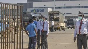 Security personnel stand guard outside Wistron Infocomm Manufacturing India Pvt Ltd at Narasapura area in Bengaluru.(PTI) Security personnel stand guard outside Wistron Infocomm Manufacturing India Pvt Ltd at Narasapura area in Bengaluru.(PTI)