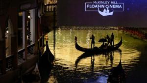 People ride on a gondola before a movie begins at a float-in cinema.(REUTERS) People ride on a gondola before a movie begins at a float-in cinema.(REUTERS)