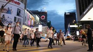 People wearing protective masks cross a street, amid the coronavirus disease (Covid-19) outbreak, in Kuala Lumpur, Malaysia.(REUTERS) People wearing protective masks cross a street, amid the coronavirus disease (Covid-19) outbreak, in Kuala Lumpur, Malaysia.(REUTERS)