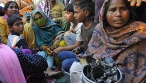 Kalawati shows blackened lumps of metal, all that has remained of Rupali’s jewellery, as her daugher (in blue) watches.(Keshav Singh/HT) Kalawati shows blackened lumps of metal, all that has remained of Rupali’s jewellery, as her daugher (in blue) watches.(Keshav Singh/HT)