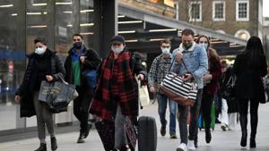 Travellers walk outside of King's Cross station as the British government imposes a stricter tiered set of restrictions amid the coronavirus disease pandemic, in London on December 20.(Reuters Photo) Travellers walk outside of King's Cross station as the British government imposes a stricter tiered set of restrictions amid the coronavirus disease pandemic, in London on December 20.(Reuters Photo)