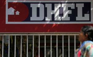 A woman walks past a signboard of Dewan Housing Finance Corporation Ltd. (DHFL) outside its office on the outskirts of Mumbai.(REUTERS) A woman walks past a signboard of Dewan Housing Finance Corporation Ltd. (DHFL) outside its office on the outskirts of Mumbai.(REUTERS)