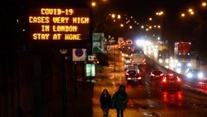 A sign reads "Covid-19 Cases Very High in London. Stay at Home" near a highway in London, UK.(Bloomberg) A sign reads "Covid-19 Cases Very High in London. Stay at Home" near a highway in London, UK.(Bloomberg)