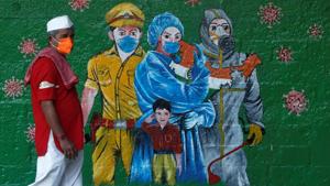 A man wearing a protective mask walks past a mural of frontline workers amidst the spread of the coronavirus disease in Mumbai.(REUTERS) A man wearing a protective mask walks past a mural of frontline workers amidst the spread of the coronavirus disease in Mumbai.(REUTERS)