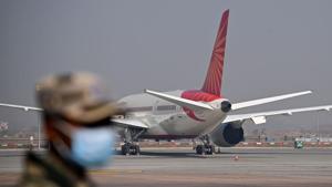A security personnel stands guard near the Cargo Terminal 2 of the Indira Gandhi International Airport, which will be used as a Covid-19 coronavirus vaccines handling and distribution center during the media preview in New Delhi.(AFP) A security personnel stands guard near the Cargo Terminal 2 of the Indira Gandhi International Airport, which will be used as a Covid-19 coronavirus vaccines handling and distribution center during the media preview in New Delhi.(AFP)