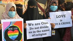 Activists belonging to various human and civil rights organisations hold placards during a demonstration condemning the decision of various Bharatiya Janata Party (BJP) led state governments in the country for the proposed passing of laws against Activists belonging to various human and civil rights organisations hold placards during a demonstration condemning the decision of various Bharatiya Janata Party (BJP) led state governments in the country for the proposed passing of laws against