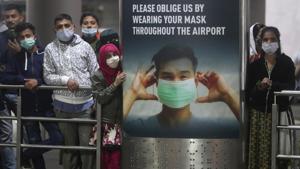 People wearing face masks as a precaution against the coronavirus wait for their relatives arriving from United Kingdom, at Chhatrapati Shivaji Maharaj International Airport in Mumbai.(AP) People wearing face masks as a precaution against the coronavirus wait for their relatives arriving from United Kingdom, at Chhatrapati Shivaji Maharaj International Airport in Mumbai.(AP)