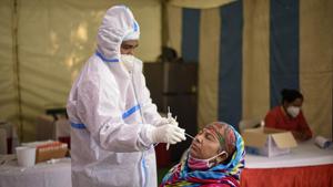 A health worker in PPE coveralls collects a swab sample from a person for coronavirus screening at a temporary testing facility in Sarai Kale Khan, New Delhi.(Biplov Bhuyan/HT PHOTO) A health worker in PPE coveralls collects a swab sample from a person for coronavirus screening at a temporary testing facility in Sarai Kale Khan, New Delhi.(Biplov Bhuyan/HT PHOTO)