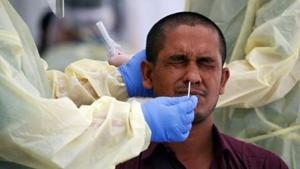 Medical workers perform a nose swab on a migrant worker at a dormitory, amid the coronavirus disease (Covid-19) outbreak in Singapore,(REUTERS) Medical workers perform a nose swab on a migrant worker at a dormitory, amid the coronavirus disease (Covid-19) outbreak in Singapore,(REUTERS)