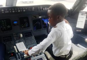 Ugandan "Captain" Graham Shema, 7, is seen inside the cockpit of a Bombardier CRJ900 aircraft at the Entebbe International Airport.(REUTERS) Ugandan "Captain" Graham Shema, 7, is seen inside the cockpit of a Bombardier CRJ900 aircraft at the Entebbe International Airport.(REUTERS)