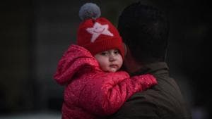 A man and child seen in warm clothes on a winter day at Connaught Place in New Delhi.(Sanchit Khanna/HT PHOTO) A man and child seen in warm clothes on a winter day at Connaught Place in New Delhi.(Sanchit Khanna/HT PHOTO)