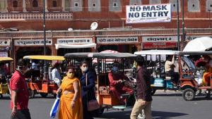 Commuters wearing facemasks as a preventive measure against the Covid-19 coronavirus make their way through a market in Jaipur.(AFP) Commuters wearing facemasks as a preventive measure against the Covid-19 coronavirus make their way through a market in Jaipur.(AFP)