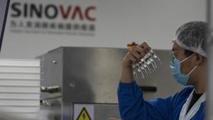 A worker inspects syringes of a vaccine for Covid-19 produced by Sinovac at its factory in Beijing.(AP) A worker inspects syringes of a vaccine for Covid-19 produced by Sinovac at its factory in Beijing.(AP)