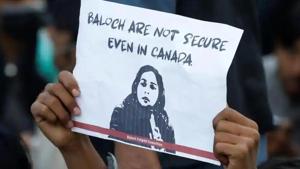 A person holds a placard to condemn the death of Karima Baloch, a Pakistani human rights activist living in Canada, who went missing and was found dead.(Reuters) A person holds a placard to condemn the death of Karima Baloch, a Pakistani human rights activist living in Canada, who went missing and was found dead.(Reuters)