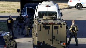 Federal agents could be seen looking around the property, searching the home and the backyard.(Reuters Photo) Federal agents could be seen looking around the property, searching the home and the backyard.(Reuters Photo)
