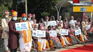 In this handout photograph taken on December 27, 2020 and released by Narayan Seva Sansthan (NSS), differently-abled and underprivileged couples wearing facemasks to contain the spread of the Covid-19 coronavirus, pose after a mass wedding ceremony at the non-profit charitable organisation Narayan Seva Sansthan, in Udaipur, in the Indian state of Rajasthan.(AFP) In this handout photograph taken on December 27, 2020 and released by Narayan Seva Sansthan (NSS), differently-abled and underprivileged couples wearing facemasks to contain the spread of the Covid-19 coronavirus, pose after a mass wedding ceremony at the non-profit charitable organisation Narayan Seva Sansthan, in Udaipur, in the Indian state of Rajasthan.(AFP)
