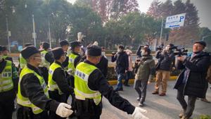 Police attempt to stop journalists from recording footage outside the Shanghai Pudong New District People's Court. (AFP) Police attempt to stop journalists from recording footage outside the Shanghai Pudong New District People's Court. (AFP)
