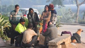 People warm themselves around a bonfire on a cold morning near Yamuna Bank metro station in New Delhi on Sunday.(Raj K Raj/HT Photo) People warm themselves around a bonfire on a cold morning near Yamuna Bank metro station in New Delhi on Sunday.(Raj K Raj/HT Photo)
