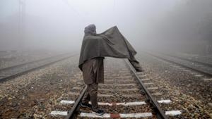 A man drapes crossing a railway track on a foggy morning in Amritsar on December 25. Under the influence of a strengthening of cold and dry northwesterly or northerly lower-level winds, “cold wave” to “severe cold wave” conditions are likely to be re-established over Punjab, Haryana, Chandigarh and Delhi from December 29 and over Rajasthan from December 29 or 30, India Meteorological Department (IMD) stated in its bulletin. (PTI) A man drapes crossing a railway track on a foggy morning in Amritsar on December 25. Under the influence of a strengthening of cold and dry northwesterly or northerly lower-level winds, “cold wave” to “severe cold wave” conditions are likely to be re-established over Punjab, Haryana, Chandigarh and Delhi from December 29 and over Rajasthan from December 29 or 30, India Meteorological Department (IMD) stated in its bulletin. (PTI)
