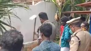 The teen digging the grave for his father while police are trying to stop him. (Videograb) The teen digging the grave for his father while police are trying to stop him. (Videograb)