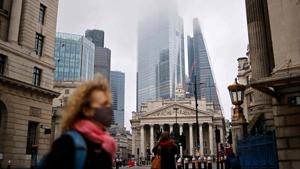 A pedestrian crosses the road near the Royal Exchange and the Bank of England in the City of London on December 28 as Londoners continue to live under Tier 4 lockdown restrictions. England is “back in the eye” of the coronavirus storm, Simon Stevens, chief executive of Britain’s National Health Service (NHS), warned on December 29, with as many patients in hospital as during the initial peak in April. (Tolga Akmen / AFP) A pedestrian crosses the road near the Royal Exchange and the Bank of England in the City of London on December 28 as Londoners continue to live under Tier 4 lockdown restrictions. England is “back in the eye” of the coronavirus storm, Simon Stevens, chief executive of Britain’s National Health Service (NHS), warned on December 29, with as many patients in hospital as during the initial peak in April. (Tolga Akmen / AFP)