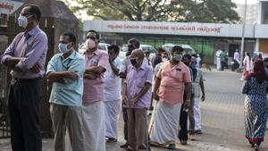 People wearing masks as a precaution against the coronavirus queue up in Kochi, Kerala state, India.(AP) People wearing masks as a precaution against the coronavirus queue up in Kochi, Kerala state, India.(AP)