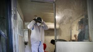 A health worker gears up to take samples to test for COVID-19 inside a mobile testing van in New Delhi.(AP) A health worker gears up to take samples to test for COVID-19 inside a mobile testing van in New Delhi.(AP)