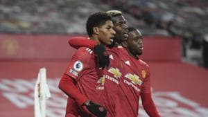 Manchester United's Marcus Rashford, left, celebrates with Paul Pogba, center, and Manchester United's Aaron Wan-Bissaka after scoring the opening goal during the English Premier League soccer match between Manchester Utd and Wolverhampton Wanderers.(AP)