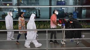 Passengers dressed in safety equipment line up to enter IGI Airport Terminal - 3, in New Delhi.(Vipin Kumar/HT PHOTO) Passengers dressed in safety equipment line up to enter IGI Airport Terminal - 3, in New Delhi.(Vipin Kumar/HT PHOTO)