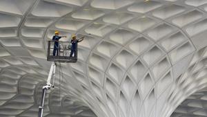 Workers clean the exterior wall roof of Terminal 2 of the Chhatrapati Shivaji International Airport, operated by GVK Power & Infrastructure Ltd at Andheri in Mumbai.(Satyabrata Tripathy/HT Photo) Workers clean the exterior wall roof of Terminal 2 of the Chhatrapati Shivaji International Airport, operated by GVK Power & Infrastructure Ltd at Andheri in Mumbai.(Satyabrata Tripathy/HT Photo)