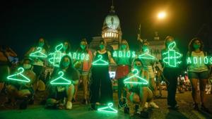 Abortion-rights activists hold hangers, that symbolise illegal abortions, and signs reading in Spanish “Goodbye” after lawmakers approved a bill that legalises abortion, in Buenos Aires, Argentina on December 30. (Victor Caivano / AP) Abortion-rights activists hold hangers, that symbolise illegal abortions, and signs reading in Spanish “Goodbye” after lawmakers approved a bill that legalises abortion, in Buenos Aires, Argentina on December 30. (Victor Caivano / AP)