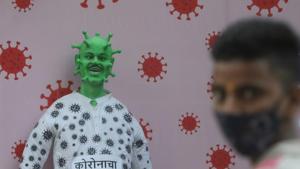A man is seen in front of an dummy representing the coronavirus disease (Covid-19) outside a housing society in Mumbai, India.(REUTERS) A man is seen in front of an dummy representing the coronavirus disease (Covid-19) outside a housing society in Mumbai, India.(REUTERS)