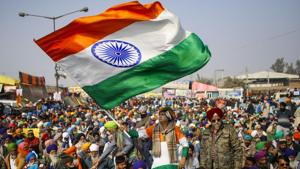 A farmer holds the Tricolor during a protest against the new farm laws, at Singhu Border in New Delhi.(PTI) A farmer holds the Tricolor during a protest against the new farm laws, at Singhu Border in New Delhi.(PTI)