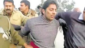 Police officers detain a man, who identified himself as Kapil Gujjar, who fired multiple shots at a site where people were protesting against a new citizenship law in New Delhi.(REUTERS) Police officers detain a man, who identified himself as Kapil Gujjar, who fired multiple shots at a site where people were protesting against a new citizenship law in New Delhi.(REUTERS)