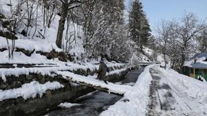 A child crossing a snow-covered wooden pavement in Tangmarg near Srinagar in Jammu and Kashmir.(HT Photo) A child crossing a snow-covered wooden pavement in Tangmarg near Srinagar in Jammu and Kashmir.(HT Photo)