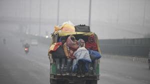 People travelling in a shared vehicle along Delhi-Gurugram Expressway amid foggy conditions and cold weather near IFFCO Chowk, in Gurugram.(Parveen Kumar/Hindustan Times)
