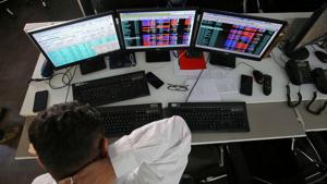 A broker reacts while trading at his computer terminal at a stock brokerage firm in Mumbai, India.(REUTERS) A broker reacts while trading at his computer terminal at a stock brokerage firm in Mumbai, India.(REUTERS)