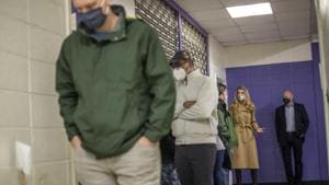 People wait in line during early voting at Chastain Park Gymnasium in Atlanta. Democrat senate candidates Jon Ossoff and Raphael Warnock are trying to unseat Republican Sens. Loeffler and David Perdue in Jan. 5 runoff elections that will determine which party controls the Senate.(AP) People wait in line during early voting at Chastain Park Gymnasium in Atlanta. Democrat senate candidates Jon Ossoff and Raphael Warnock are trying to unseat Republican Sens. Loeffler and David Perdue in Jan. 5 runoff elections that will determine which party controls the Senate.(AP)