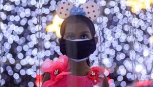 A girl wearing a protective mask looks at decorations at a mall on New Year's Eve, amid the spread of the coronavirus disease (COVID-19) in Mumbai, India.(REUTERS) A girl wearing a protective mask looks at decorations at a mall on New Year's Eve, amid the spread of the coronavirus disease (COVID-19) in Mumbai, India.(REUTERS)