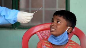 A health worker prepares to take a swab sample from a boy for the Covid-19 coronavirus RT PCR and Rapid Antigen test at a testing centre in Chennai.(AFP) A health worker prepares to take a swab sample from a boy for the Covid-19 coronavirus RT PCR and Rapid Antigen test at a testing centre in Chennai.(AFP)