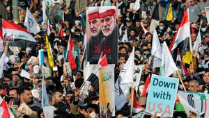 Iraqis hold placards and flags as they gather to mark the one year anniversary of the killing of Qassem Soleimani.(REUTERS) Iraqis hold placards and flags as they gather to mark the one year anniversary of the killing of Qassem Soleimani.(REUTERS)