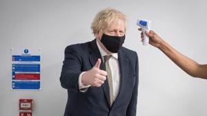 Britain's Prime Minister Boris Johnson gives a thumbs up as he has his temperature checked during a visit to Chase Farm Hospital in north London, Britain on January 4, 2021.(Reuters File Photo) Britain's Prime Minister Boris Johnson gives a thumbs up as he has his temperature checked during a visit to Chase Farm Hospital in north London, Britain on January 4, 2021.(Reuters File Photo)