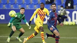 Barcelona's Ousmane Dembele in action with Huesca's Alvaro Fernandez and Pablo Insua.(REUTERS) Barcelona's Ousmane Dembele in action with Huesca's Alvaro Fernandez and Pablo Insua.(REUTERS)