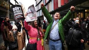 People celebrate after a British judge ruled that WikiLeaks founder Julian Assange should not be extradited to the United States, outside the Old Bailey, the Central Criminal Court, in London on January 4.(Reuters)