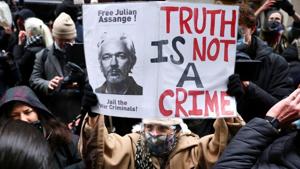 People celebrate after a judge ruled that WikiLeaks founder Julian Assange should not be extradited to the United States, outside the Old Bailey, the Central Criminal Court, in London, Britain.(Reuters) People celebrate after a judge ruled that WikiLeaks founder Julian Assange should not be extradited to the United States, outside the Old Bailey, the Central Criminal Court, in London, Britain.(Reuters)