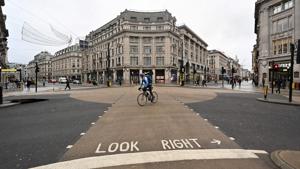 A cyclist rides across an empty Oxford Street in London as Britain heads into a national lockdown on January 5. British Prime Minister Boris Johnson on January 4 ordered England into a new national lockdown to contain a surge in Covid-19 cases that was threatening the British healthcare system before a vaccine programme reached a critical mass. (Justin Tallis / AFP) A cyclist rides across an empty Oxford Street in London as Britain heads into a national lockdown on January 5. British Prime Minister Boris Johnson on January 4 ordered England into a new national lockdown to contain a surge in Covid-19 cases that was threatening the British healthcare system before a vaccine programme reached a critical mass. (Justin Tallis / AFP)