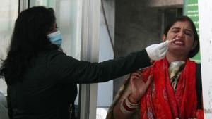 A health worker collects a nasal sample from a woman for Covid-19 test in Gurugram(ANI) A health worker collects a nasal sample from a woman for Covid-19 test in Gurugram(ANI)