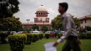 A man walks inside the premises of the Supreme Court in New Delhi.(REUTERS) A man walks inside the premises of the Supreme Court in New Delhi.(REUTERS)