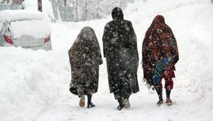 People walk on a snow-covered road during a snowfall, in Qazigund, J&K, on Monday.(ANI) People walk on a snow-covered road during a snowfall, in Qazigund, J&K, on Monday.(ANI)